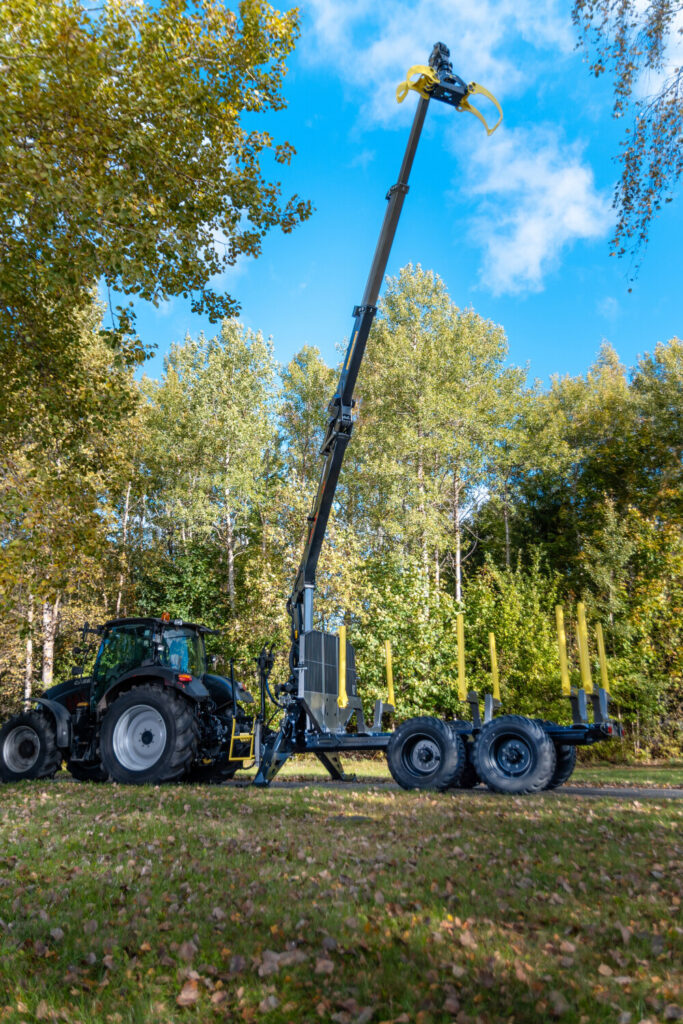 Palms 7.87 metsäkuormain ja kärry traktorin perässä, kuormain ylhäällä.