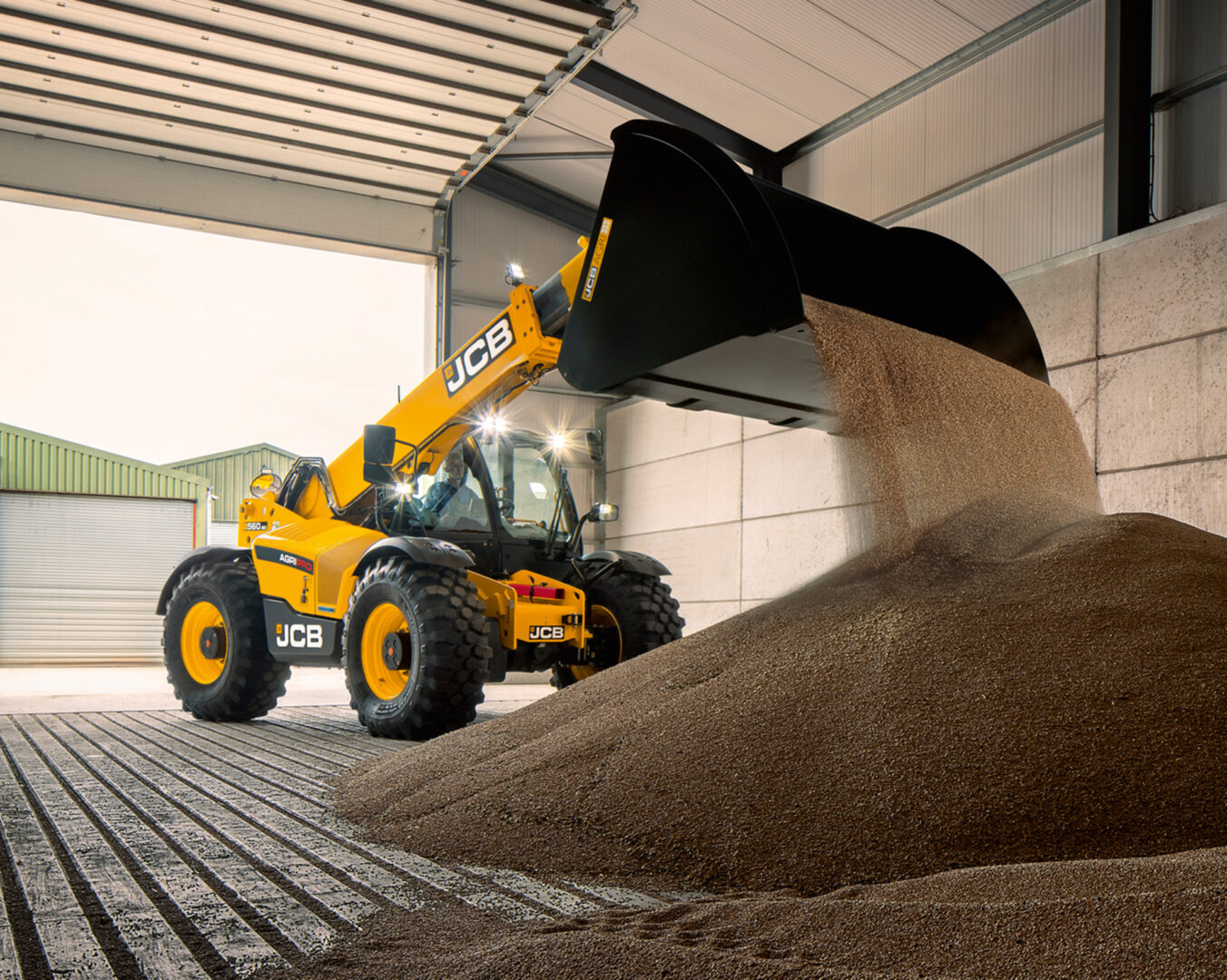 JCB 560-80 Agri -kurottaja kaatamassa viljaa.