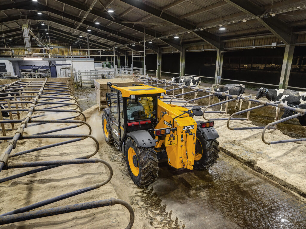 JCB 530-60 Agrisuper -kurottaja kuivittamassa navettaa.