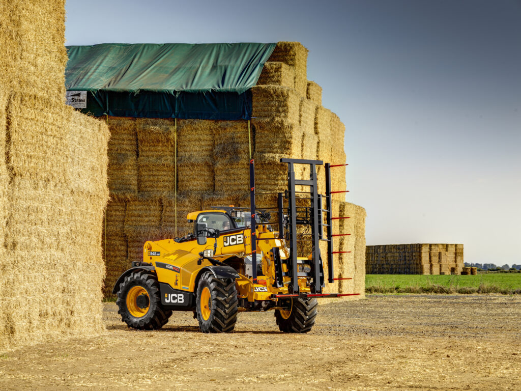 JCB 542-100 Agrisuper -kurottaja nostamassa olkipaaleja.